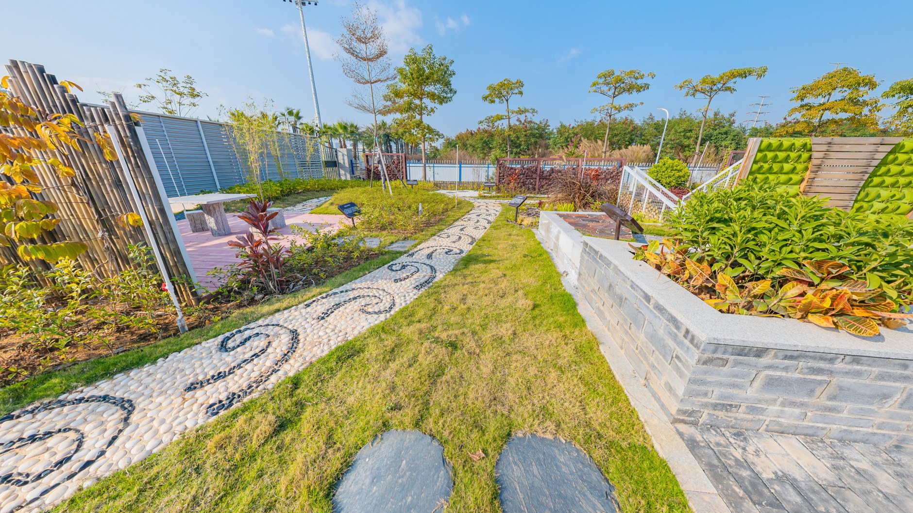 Terrace garden with mosaic stone inlay, turf bands and raised timber planters